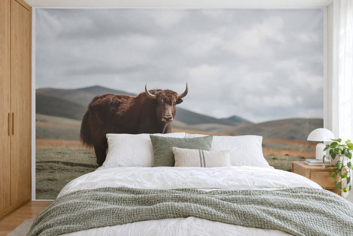 XXL printed fabric: yak with light horns at left, hills and cloudy sky at right, full wall behind the bed