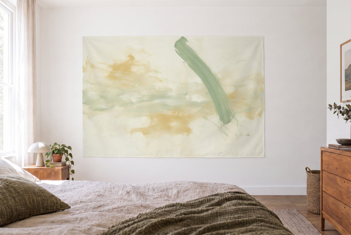 Abstract brushstrokes in sage and ochre tapestry in the bright bedroom opposite the bed, wooden dresser at right