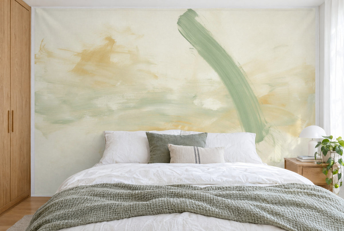XXL printed fabric: sage-green brush sweep at right over ochre and cream, filling the wall behind the bed