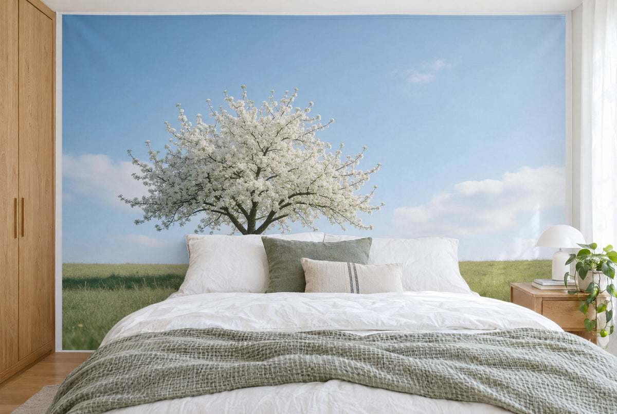 Bedruckter Stoff im XXL-Format: blühender Apfelbaum links auf der Wiese unter weitem Himmel, wandfüllend hinter dem Bett