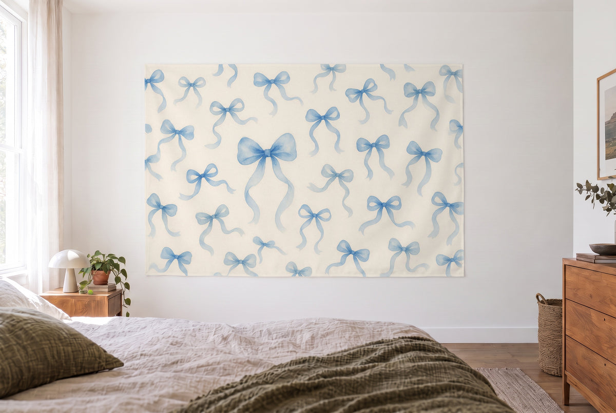 Blue bows on cream tapestry in the bright bedroom opposite the bed, wooden dresser on the right – blue and cream