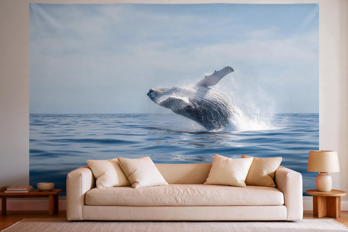 XXL wall tapestry Humpback Whale Leaping from the Sea as wall decor in a bright living room above the sofa