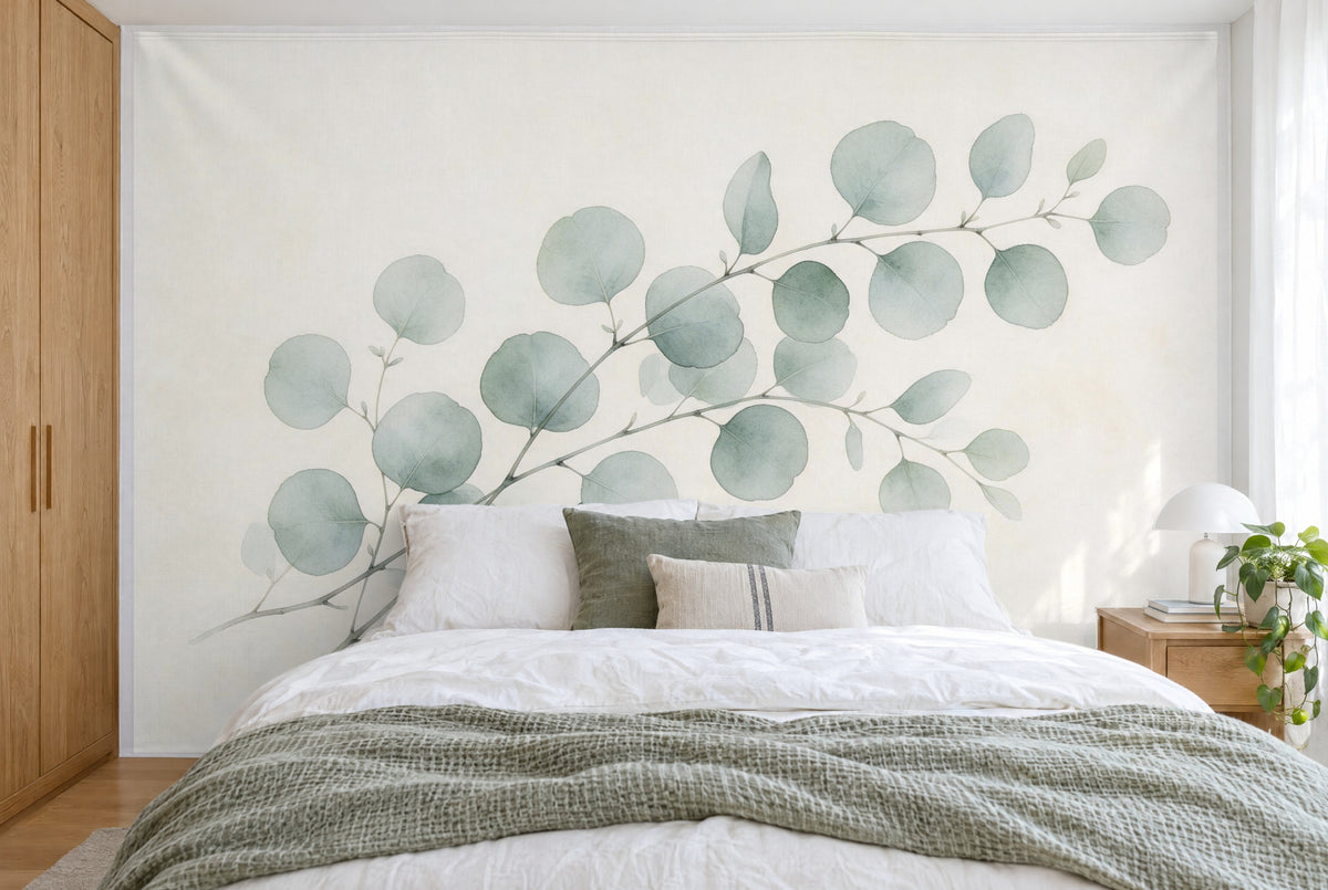 XXL printed fabric: eucalyptus branches with round leaves running diagonally up to the right, filling the wall behind the bed