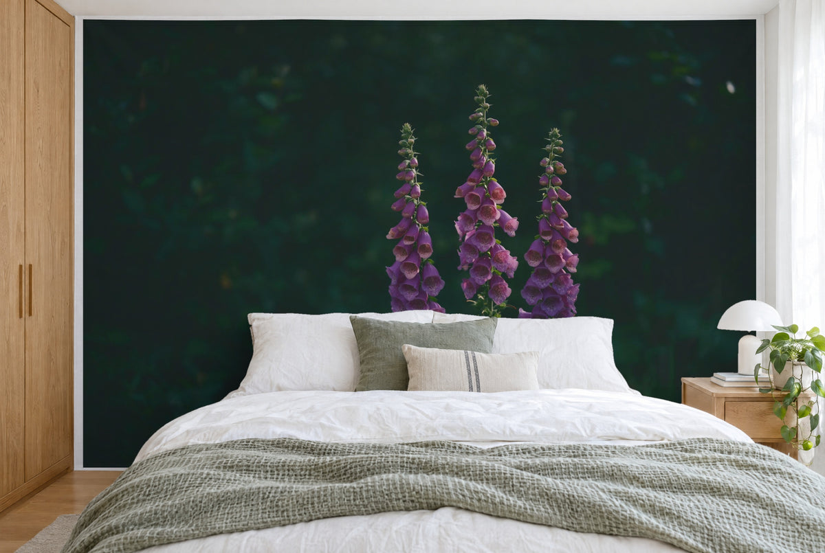 XXL printed fabric: three violet foxglove stems in the image center against dark green, filling the wall behind the bed