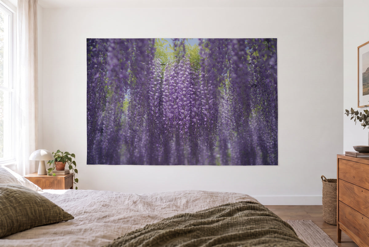 Wandtuch Blumenvorhang aus Glyzinien im hellen Schlafzimmer gegenüber dem Bett, rechts eine Holzkommode – Violett