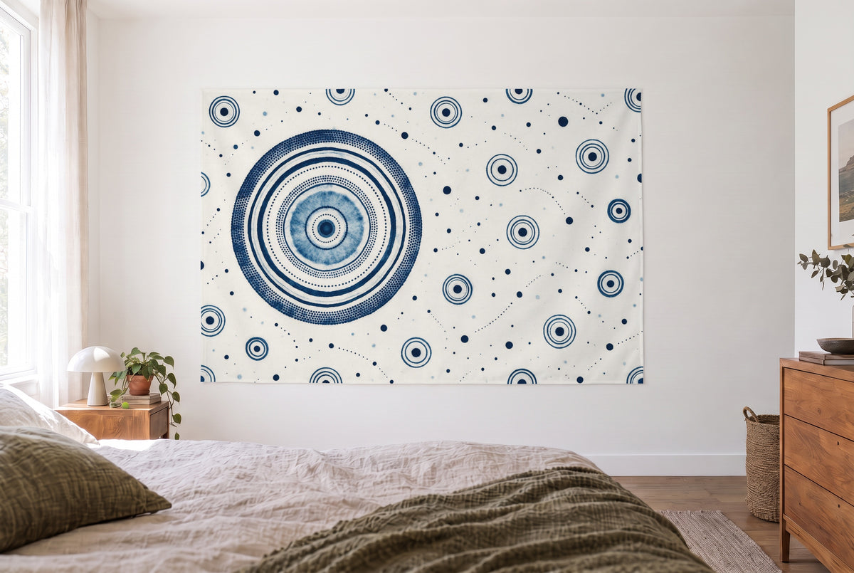 Indigo batik pattern with circles tapestry in the bright bedroom opposite the bed, wooden dresser at right – blue and white