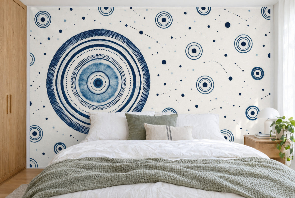 XXL printed fabric: large ring circle on the left, dots and small circles in indigo, filling the wall behind the bed