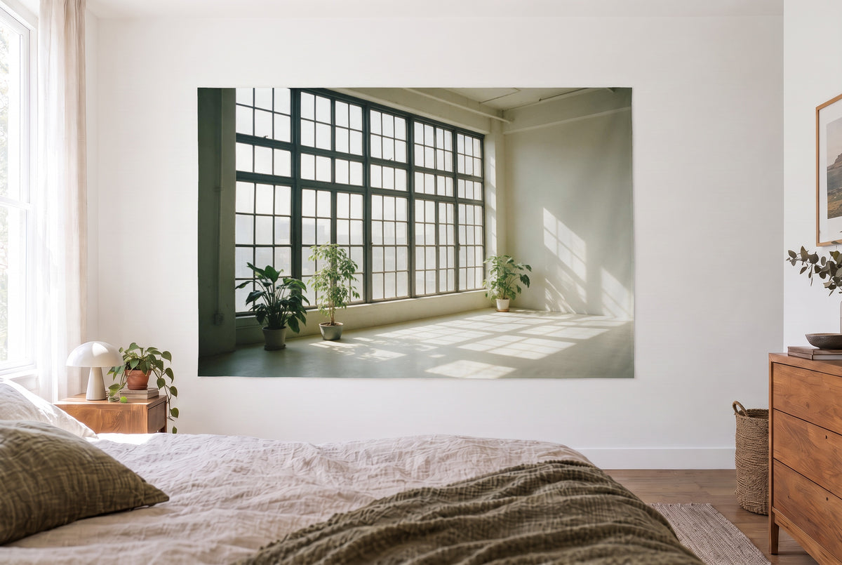 Industrial loft with grid windows tapestry in a bright bedroom opposite the bed, wooden dresser at right – grey