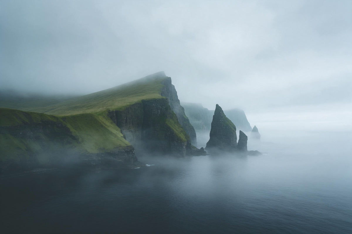 Green cliffs with rugged rock needles in fog over the dark northern sea, tapestry printed on fabric – green and blue
