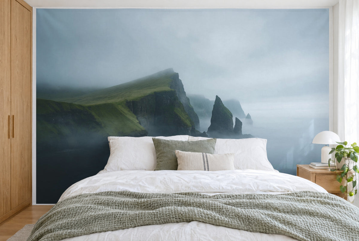 XXL printed fabric: grass-green steep coast left, rock needles in the centre, foggy sea, filling the wall behind the bed