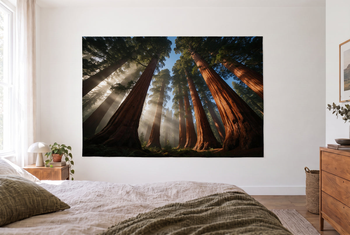 Sequoia Crowns from Below tapestry in a bright bedroom opposite the bed, wooden dresser at right – brown and green
