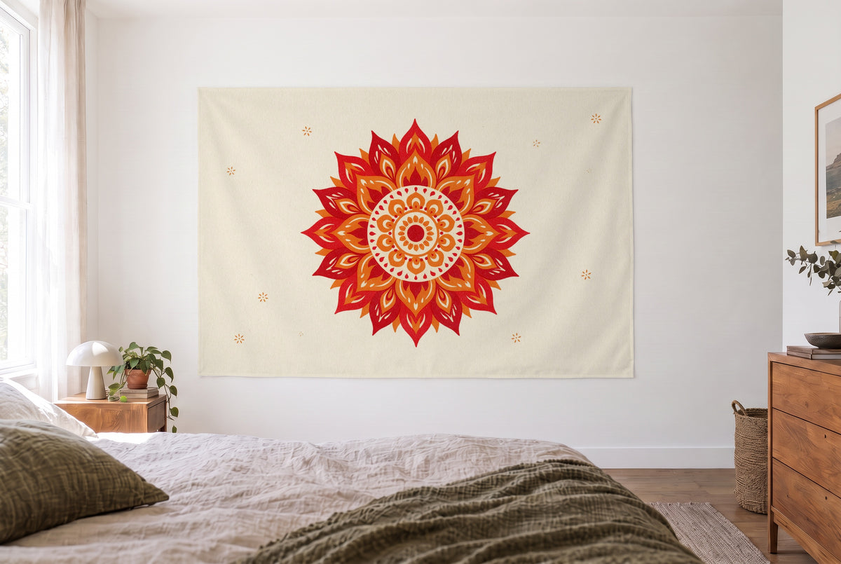Tenture mandala rouge et orange dans une chambre claire face au lit, une commode en bois à droite – rouge et crème