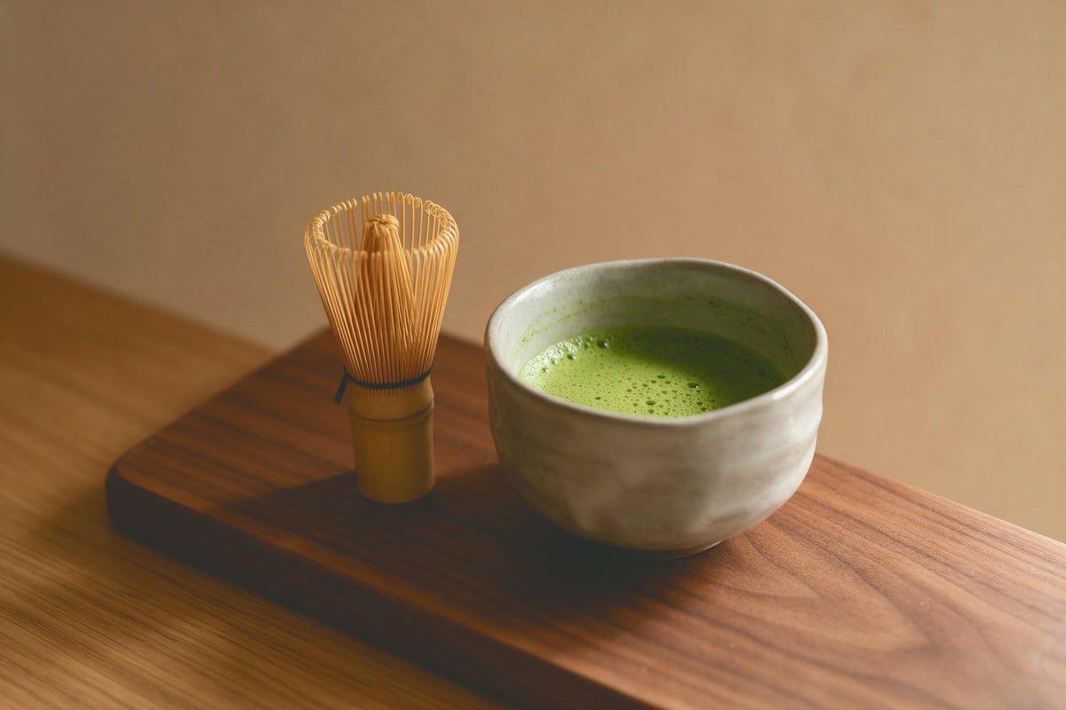 Matcha-Teeschale mit grünem Schaum und Bambusbesen auf nussbraunem Holzbrett, als Wandtuch, auf Stoff gedruckt – Grün