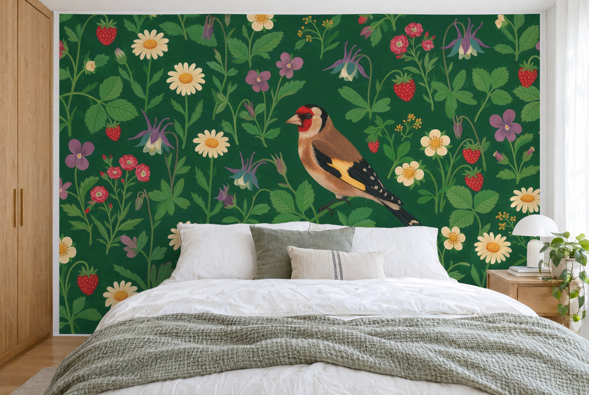XXL printed fabric: Distelfink slightly to the right among strewn flowers on deep green, filling the wall behind the bed