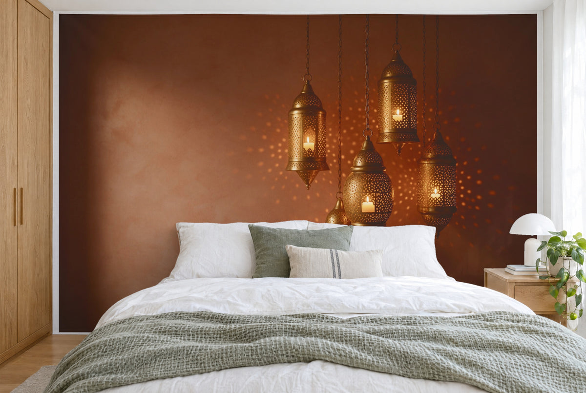 XXL printed fabric: five glowing brass lanterns at right against terracotta, filling the wall behind the bed