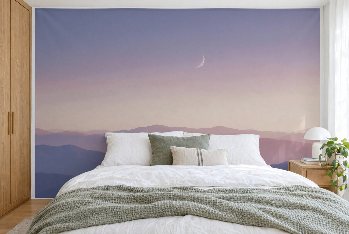 XXL printed fabric: pale crescent moon top right above blue and pink mountain ridges, filling the wall behind the bed