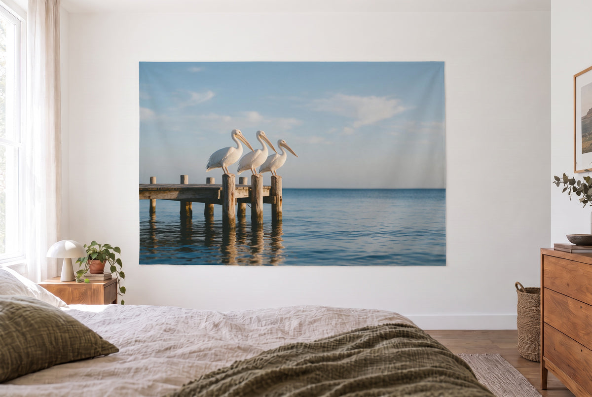 Pelicans on the Wooden Pier tapestry in the bright bedroom opposite the bed, wooden dresser at right – beige and blue