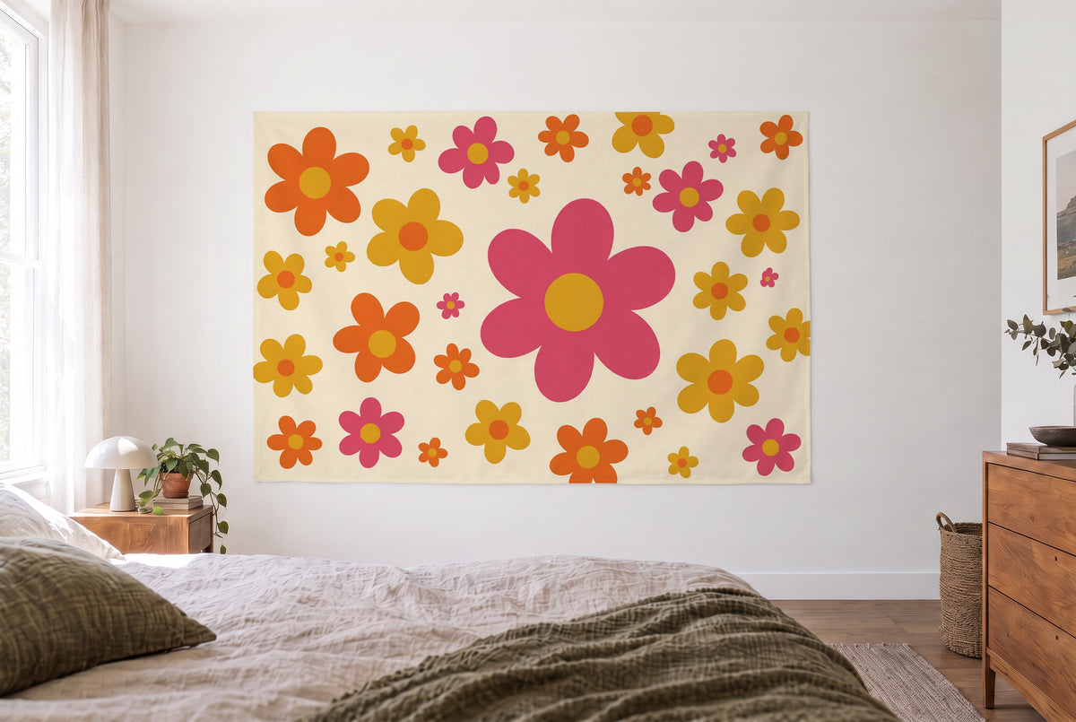 Seventies retro flowers tapestry in a bright bedroom opposite the bed, wooden dresser at right – orange and pink