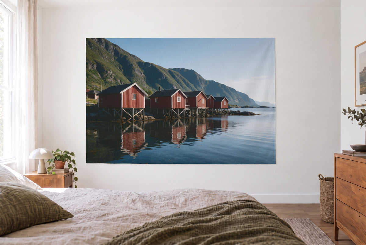 Tenture cabanes de pêcheurs rouges au fjord dans la chambre claire face au lit, commode en bois à droite – rouge et bleu