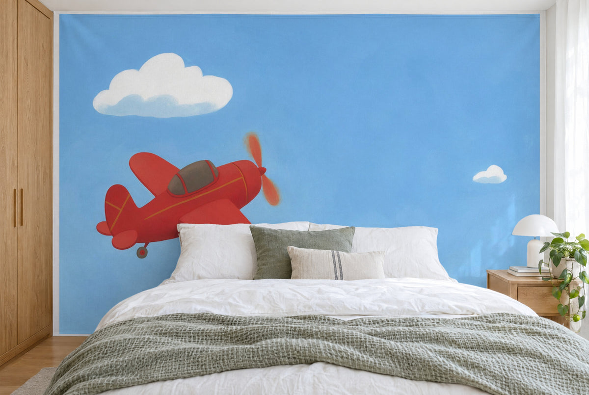 XXL printed fabric: red plane at left below a cloud, open sky at right, filling the wall behind the bed
