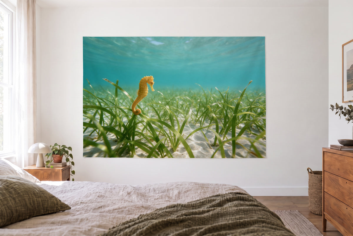 Seagrass meadow underwater tapestry in the bright bedroom opposite the bed, wooden dresser at right – turquoise and green