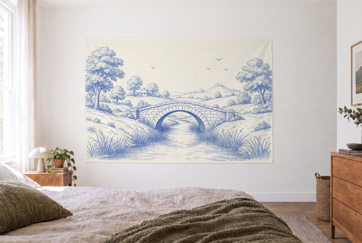 Toile de Jouy tapestry with stone bridge in blue in a bright bedroom opposite the bed, wooden dresser at right