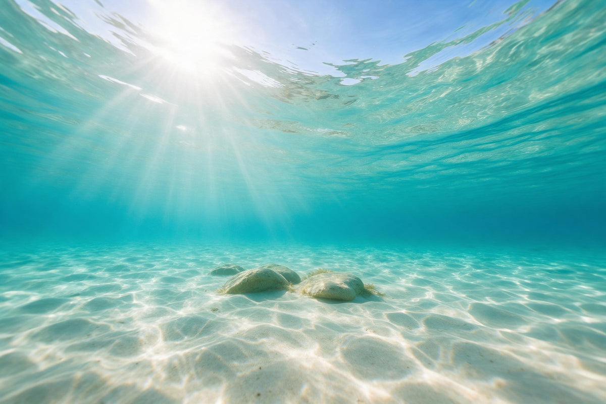 Rayos de sol en abanico arriba a la izquierda en agua turquesa sobre fondo de arena clara, tapiz impreso en tela – turquesa