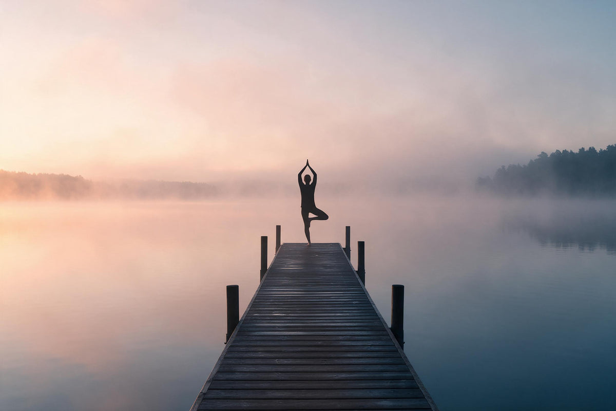 Yoga silhouette in tree pose on a wooden jetty by a misty lake under the rising sun, tapestry printed on fabric