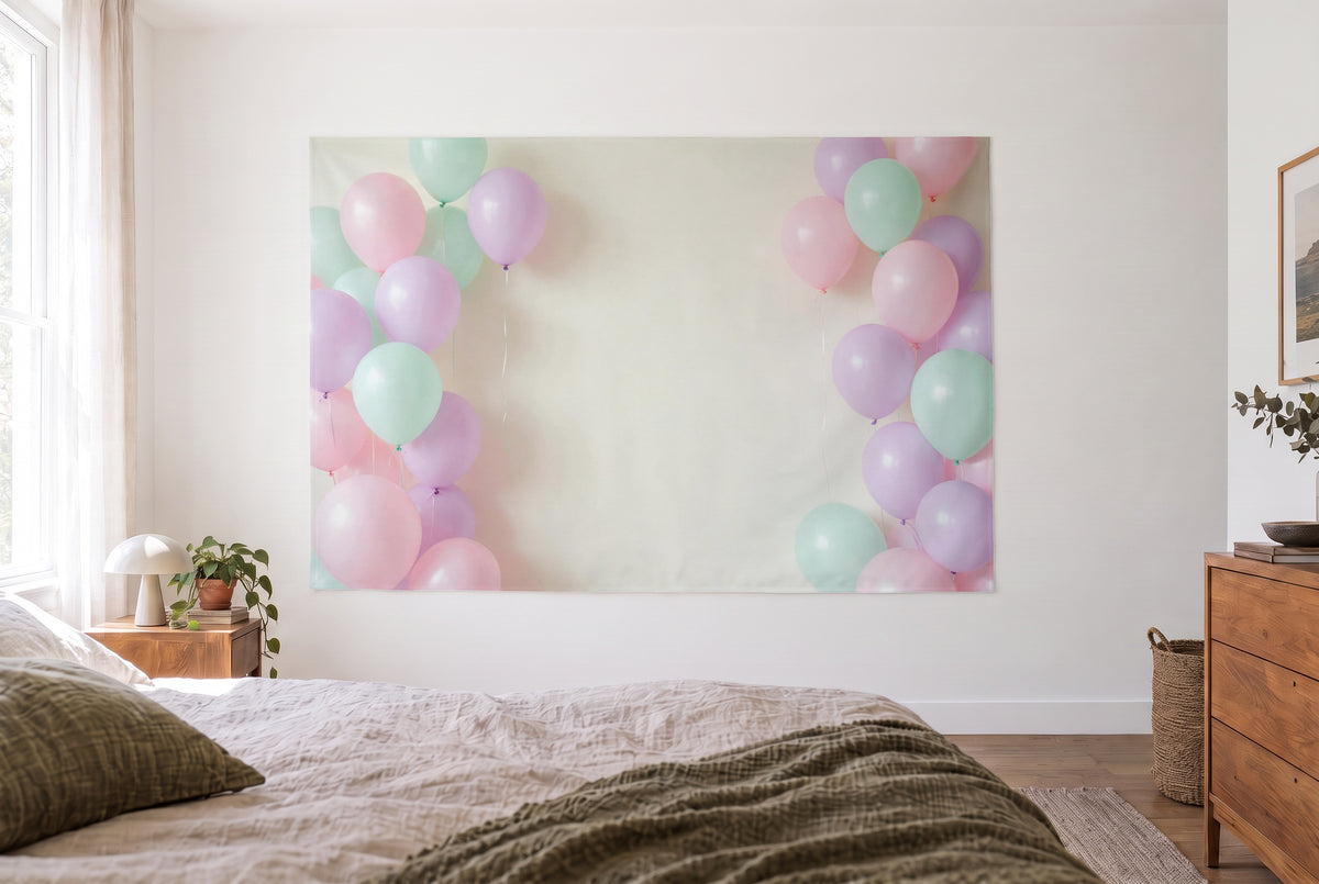 Pastel balloon cloud tapestry in a bright bedroom opposite the bed, wooden dresser on the right – pink, green and violet