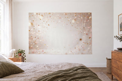 Gold confetti rain tapestry in a bright bedroom opposite the bed, wooden dresser on the right – gold, pink and white