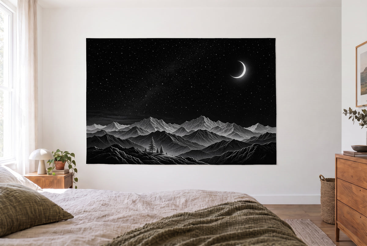 Tenture nuit étoilée sur les montagnes dans une chambre claire face au lit, commode en bois à droite – noir
