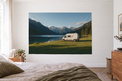 Camper van mountain lake tapestry in the bright bedroom opposite the bed, wood dresser on the right – green, blue and white