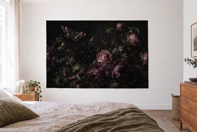Dark Botanical with Moths tapestry in a bright bedroom opposite the bed, a wooden dresser on the right – black and dusty pink