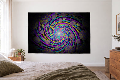 Trippy Color Spiral tapestry in a bright bedroom opposite the bed, wooden dresser at right – violet, turquoise and yellow