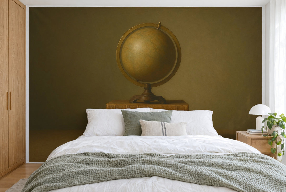 XXL printed fabric: old globe in the centre on a stack of books by an olive-brown wall, filling the wall behind the bed