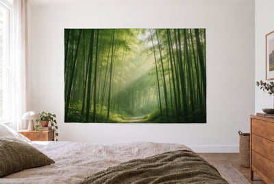 Bamboo Forest in Morning Light tapestry in a bright bedroom opposite the bed, wooden dresser at right – green and gold