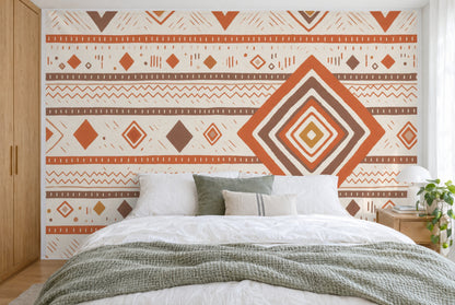 XXL printed fabric: large diamond on the right, zigzag lines and stripes in earth tones, filling the wall behind the bed