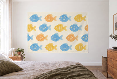 Tapiz peces de colores en estampado en un dormitorio claro frente a la cama, cómoda de madera a la derecha – azul y amarillo