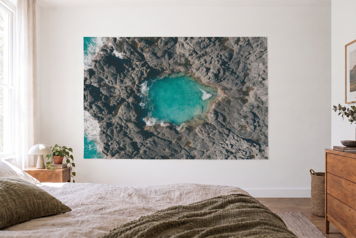 Rock Pool on the Coast from Above tapestry in the bright bedroom opposite the bed, wooden dresser at right – turquoise