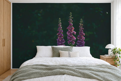 XXL printed fabric: three violet foxglove stems in the image center against dark green, filling the wall behind the bed
