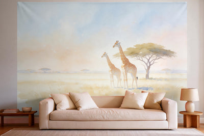 XXL wall tapestry Giraffes Under Acacias in Watercolor as wall decor in a bright living room above the sofa
