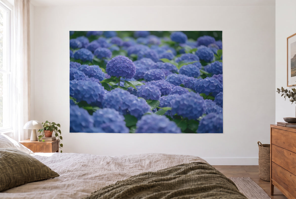 Tapiz hortensias azules en plena floración en el dormitorio claro frente a la cama, cómoda de madera a la derecha – azul