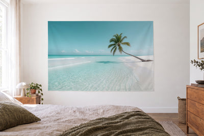 Caribbean Beach with Palm Tree tapestry in a bright bedroom opposite the bed, wooden dresser at right – turquoise and white