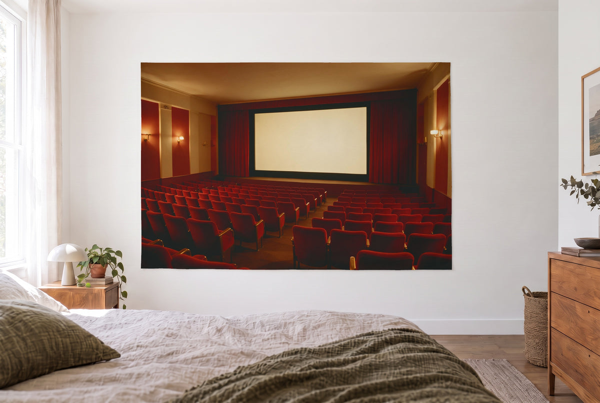 Empty cinema red seats tapestry in the bright bedroom opposite the bed, wood dresser on the right – red and gold