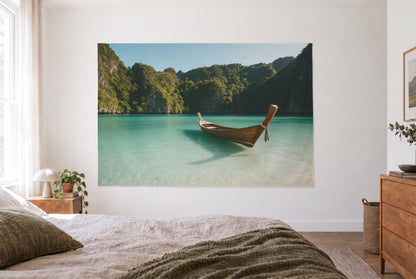 Longtail boat by limestone cliffs tapestry in a bright bedroom opposite the bed, wooden dresser right – turquoise and green