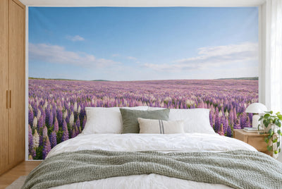 Tela impresa XXL: lupinos en flor en la mitad inferior, cielo azul encima, pared entera tras la cama
