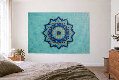 Mosaic mandala tapestry in a bright bedroom opposite the bed, wooden dresser on the right – turquoise and blue