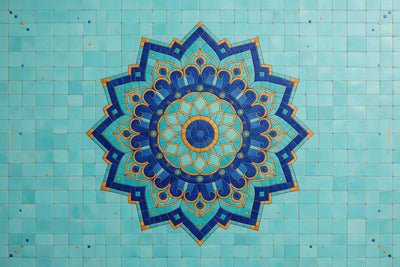 Mandala of small mosaic tiles in cobalt blue and ochre in the centre on turquoise tiles, tapestry printed on fabric