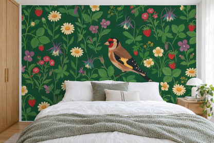 XXL printed fabric: Distelfink slightly to the right among strewn flowers on deep green, filling the wall behind the bed
