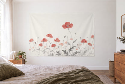 Poppy field in ink tapestry in a bright bedroom opposite the bed, wooden dresser at right – red and white